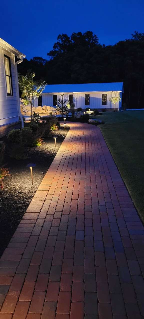 Brick walkway lit with warm path lighting at dusk